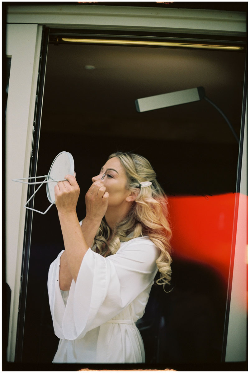Bride getting ready in morning light photographed on 35mm film