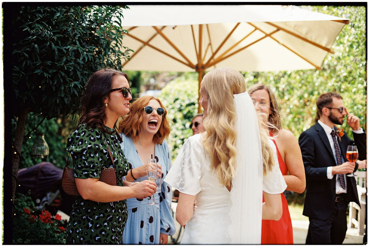 Candid wedding guest moments captured on 35mm film
