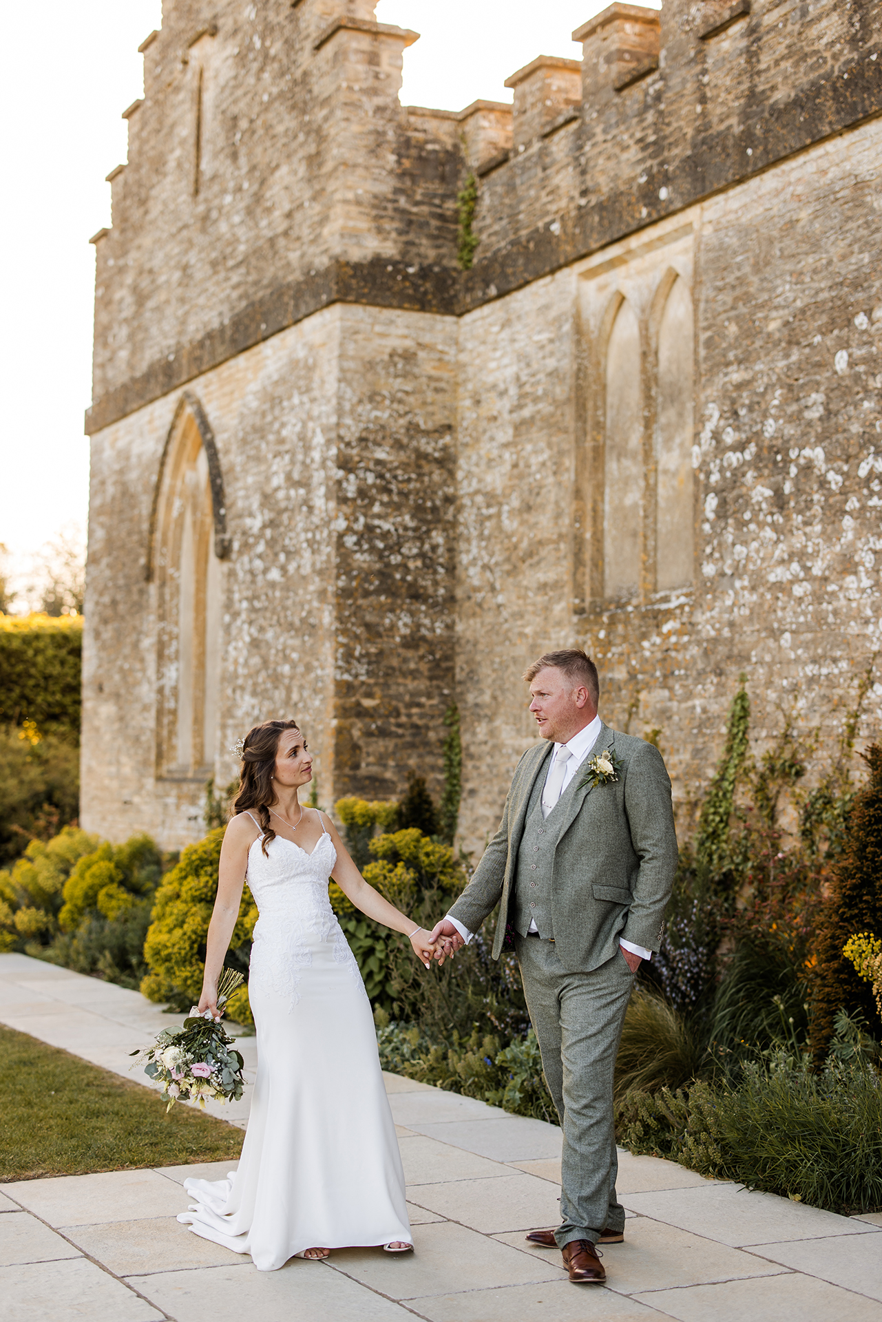 Bride and groom standing outside Ivy lodge Cirencester 