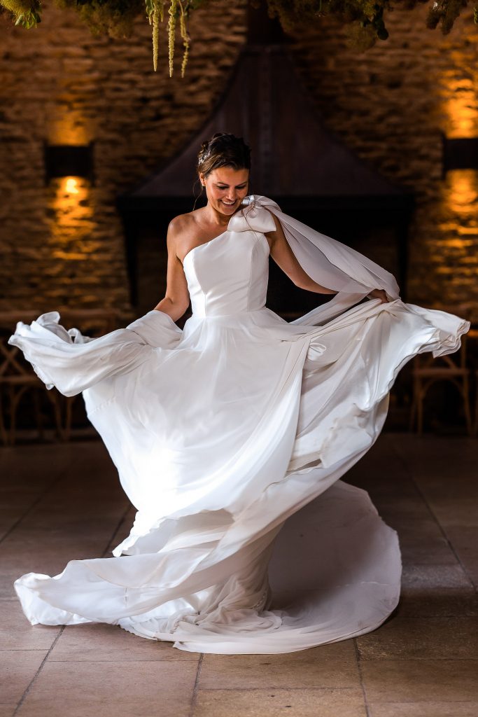 Bride swishing her wedding dress