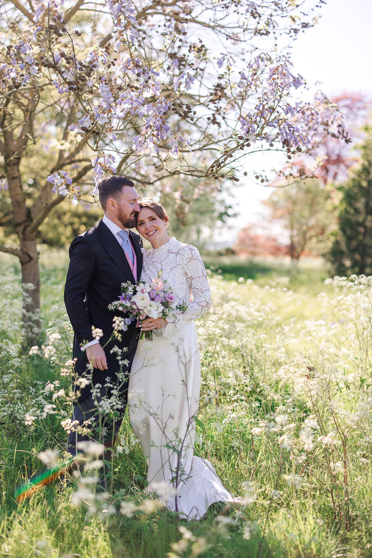 Bride on the lawn outside Elmore Court standing in the flowers