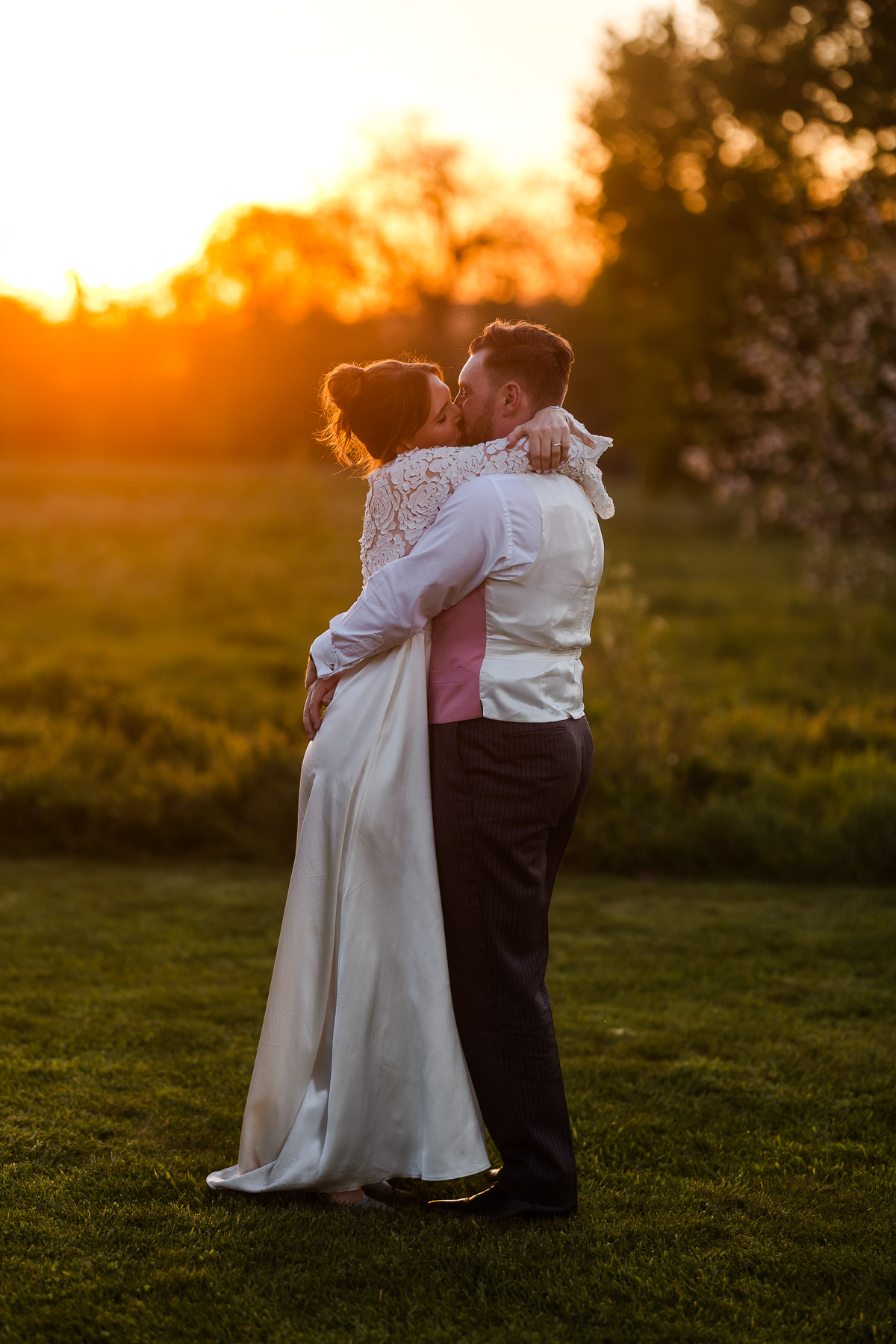 Bride and Groom Kissing at sunset at Elmore Court