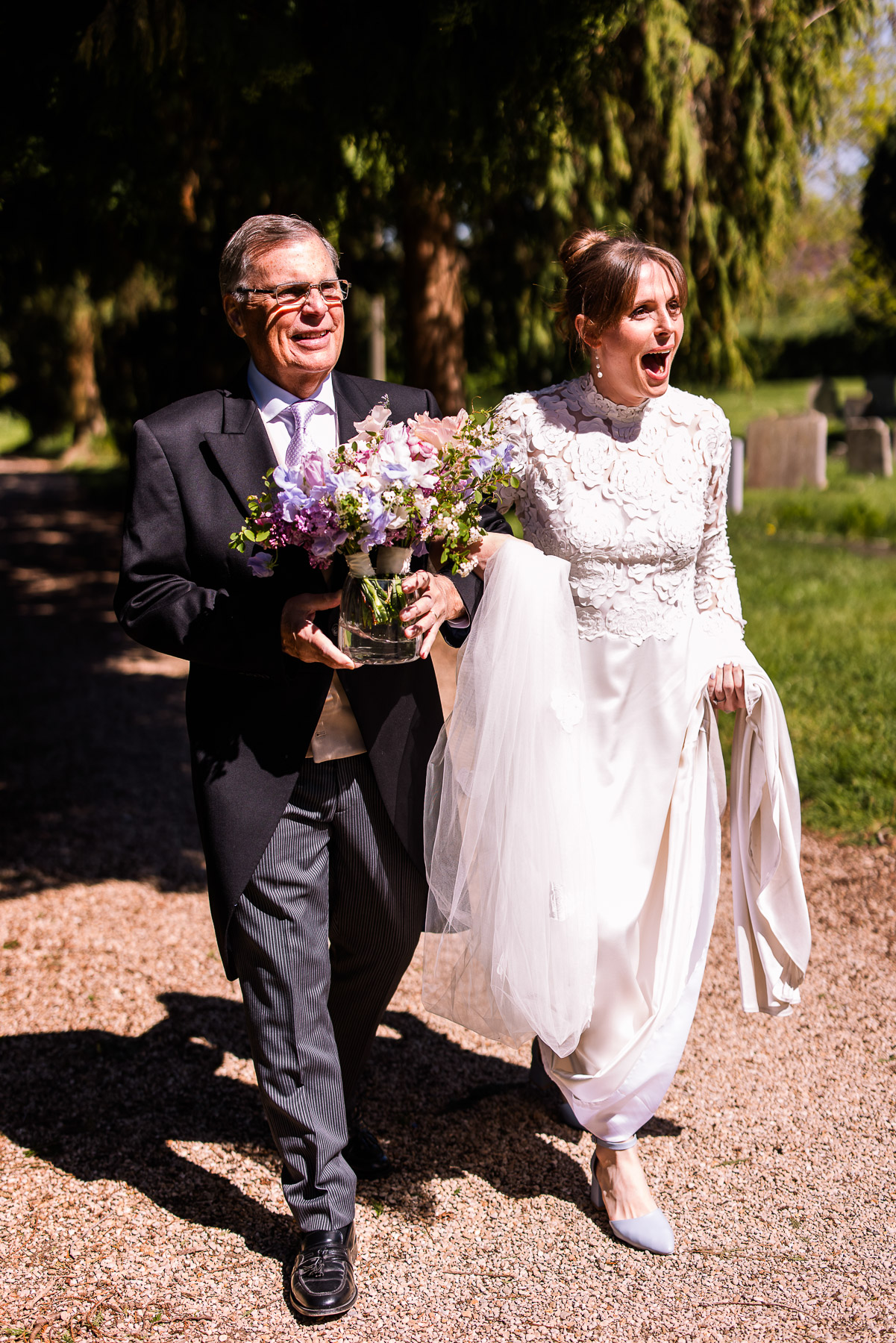 The bride spotting her flowers outside Elmore Church 