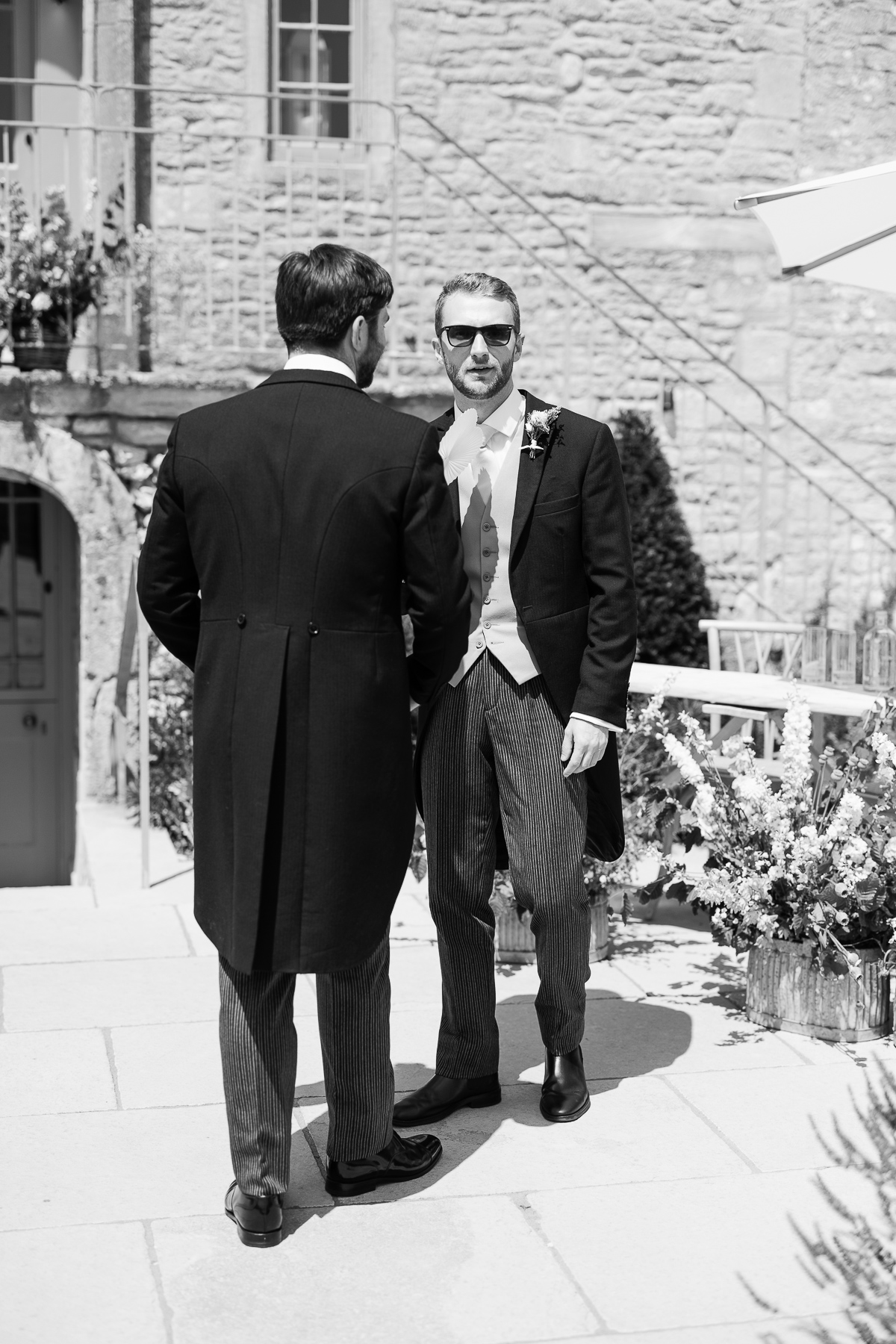 Groom and Best man standing outside Ivy Lodge 