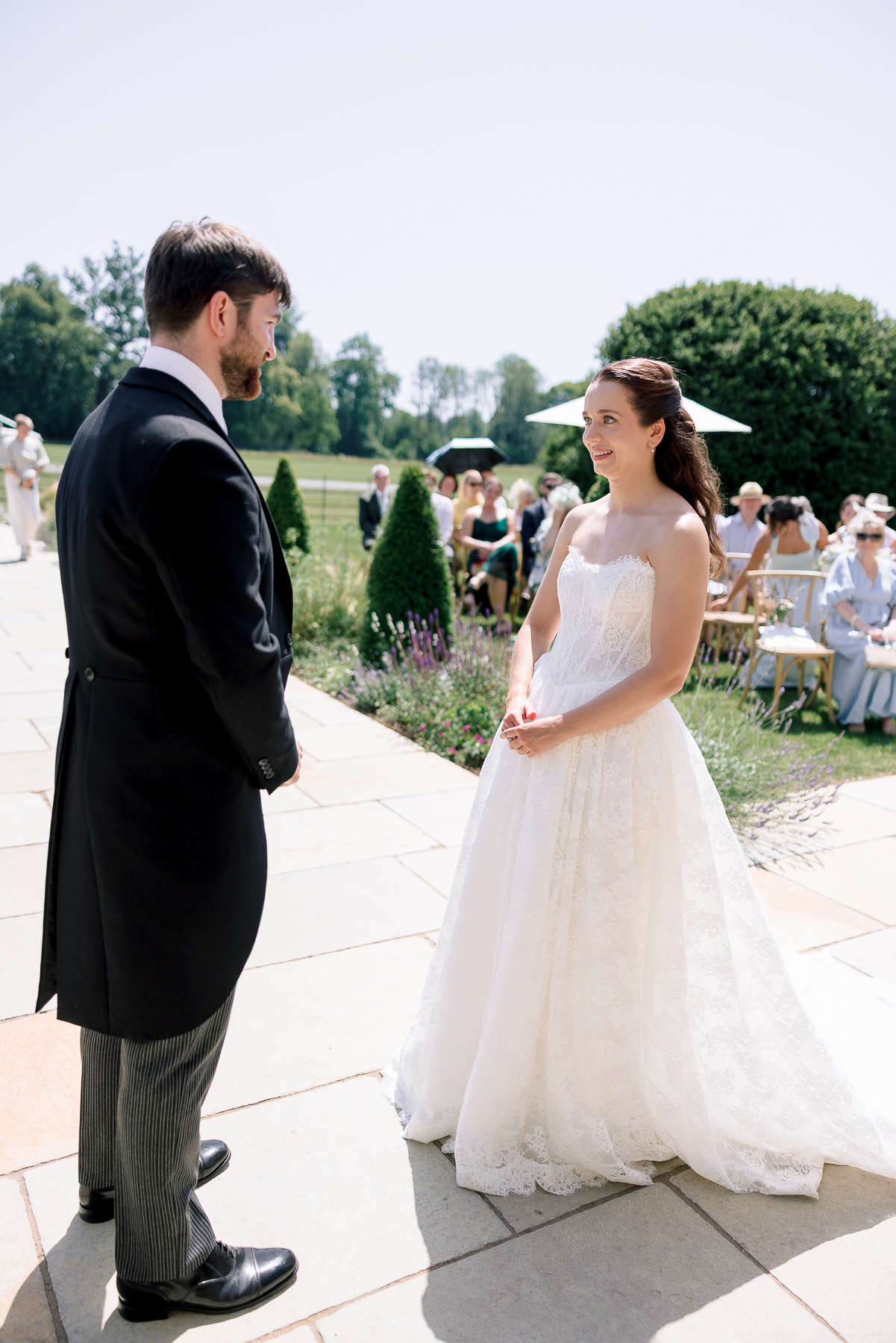 The bride and groom standing side by side at Ivy lodge making their vows 