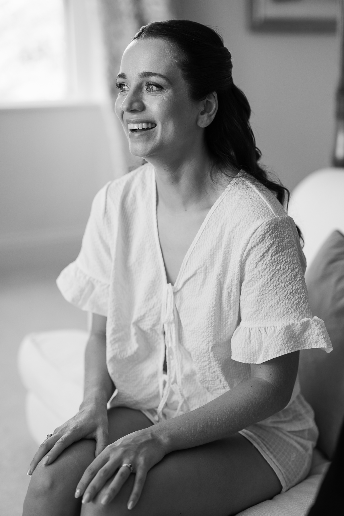 The bride smiling during prep 