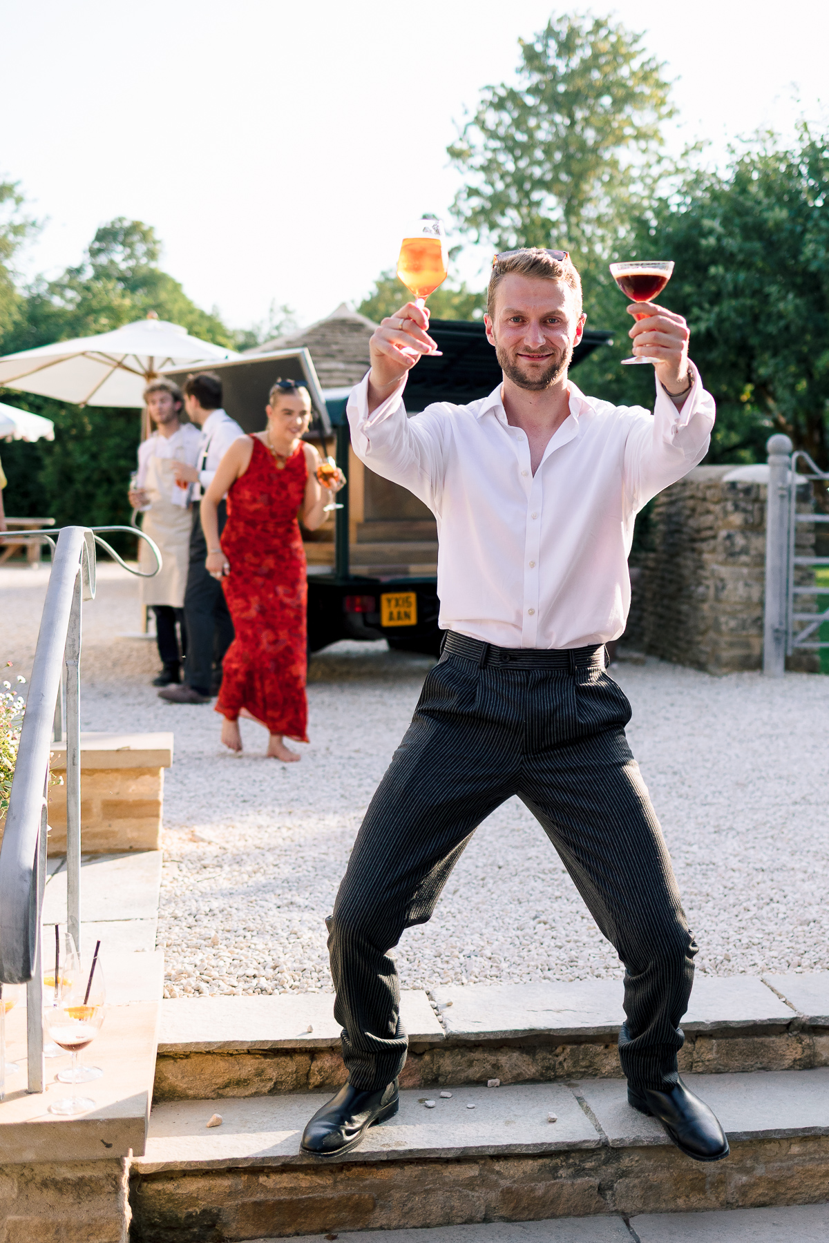 Man posing while holing drinks 