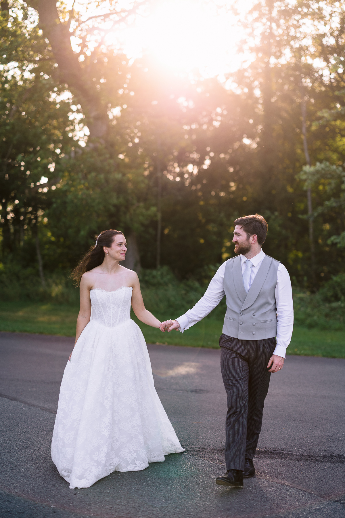 Bride and groom walking in golden hour 