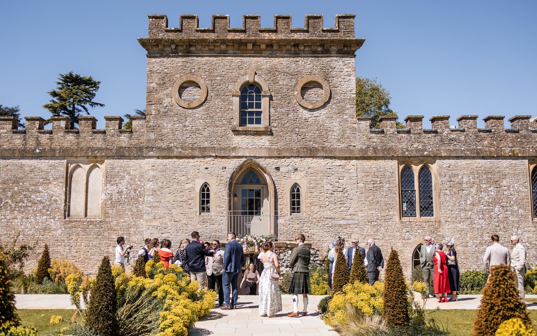 Front view of Ivy Lodge in Cirencester with guests standing outside in the sunshine