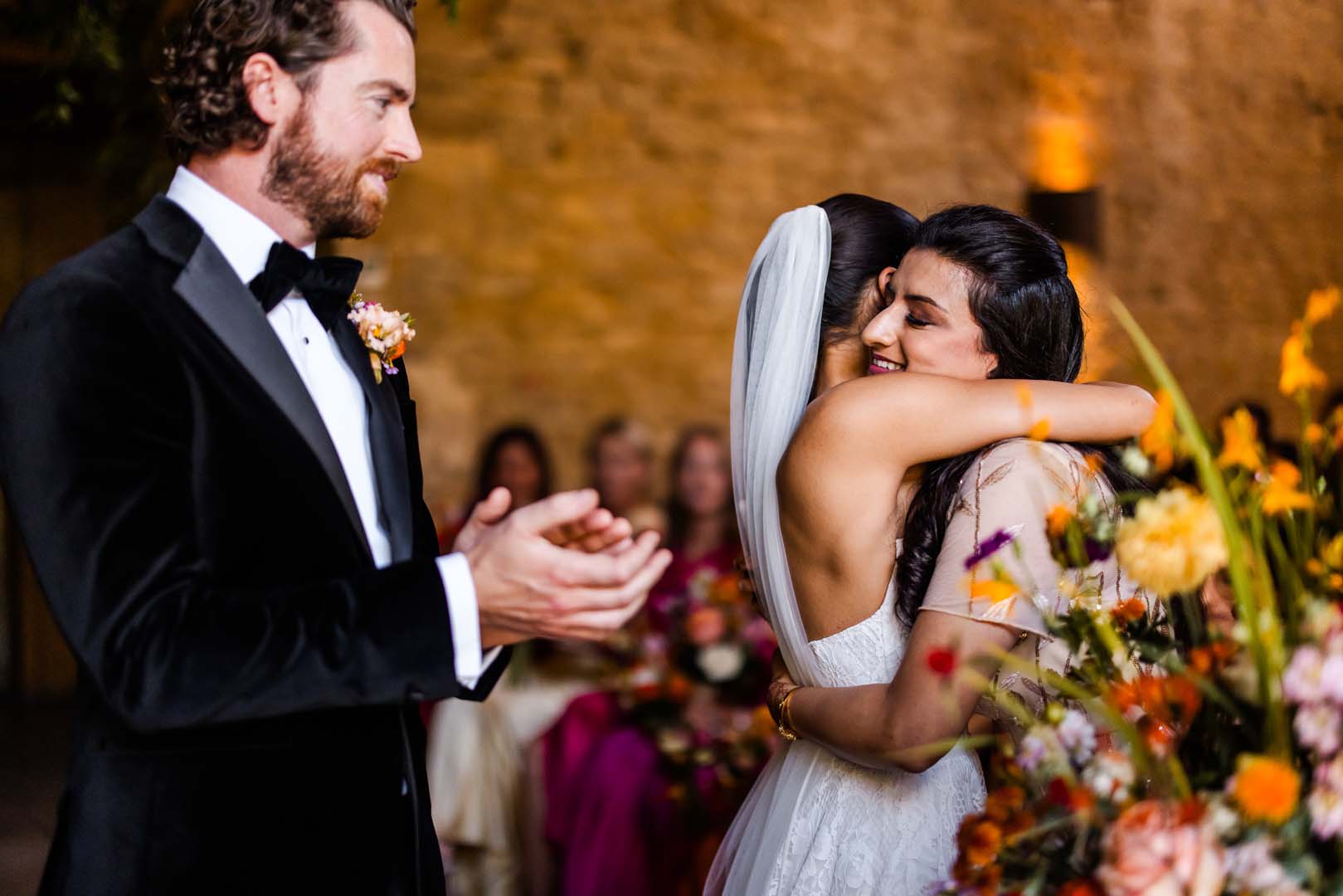Couples up on the shoulders of their friends on the dancefloor